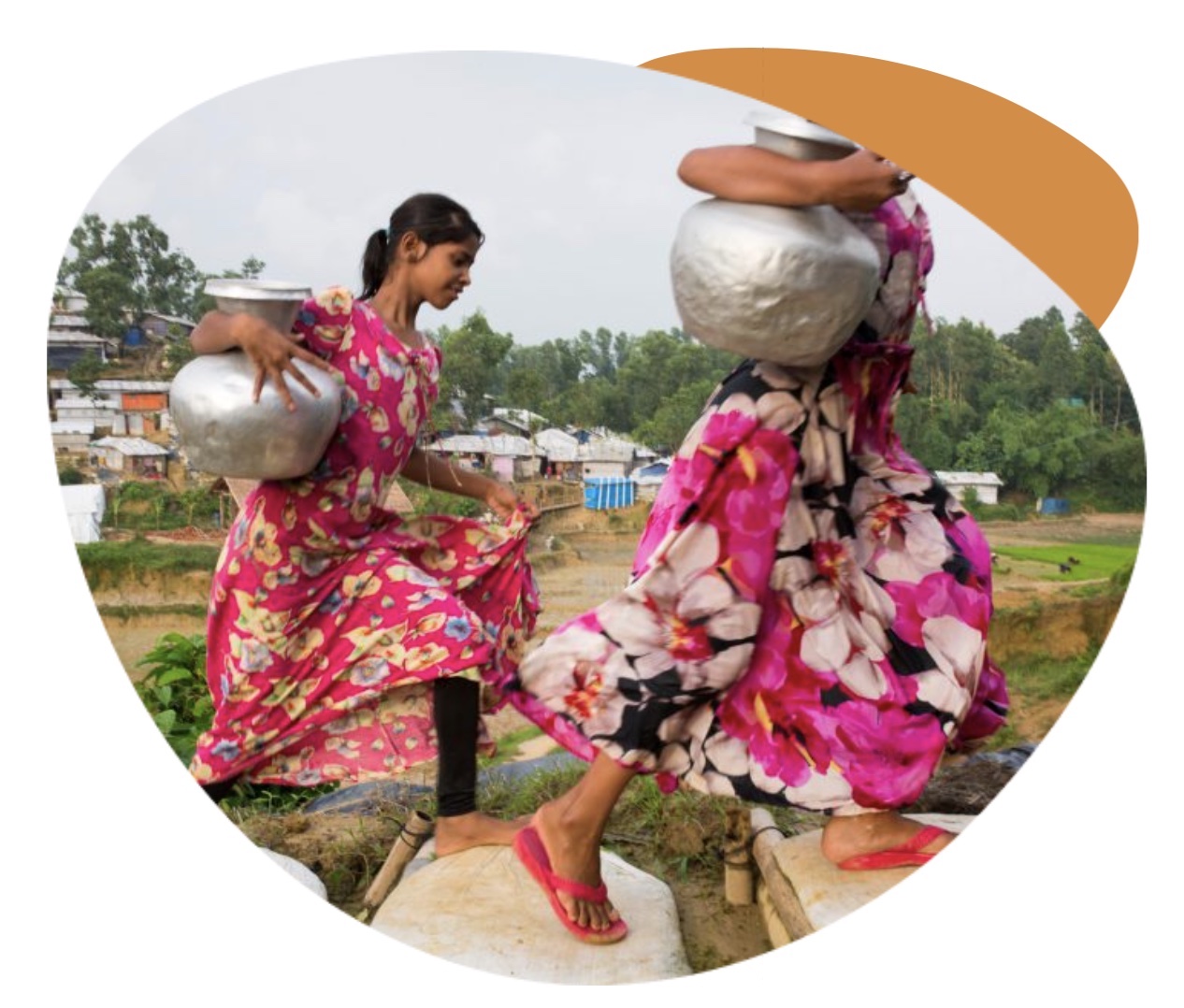 Two young women carrying vessels of water