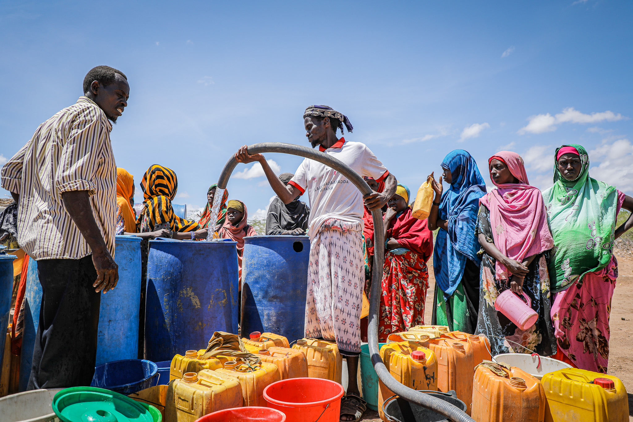 People queuing to get clean water after floods destroyed infrastructure in southern Somalia in May 2023