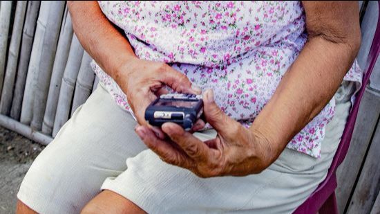 A person views their mobile phone